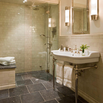 Inspiration for a timeless beige tile and subway tile black floor alcove shower remodel in Denver with a console sink