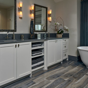 Gray and White Bathroom with Freestanding Tub, Faux Wood Tile Floor