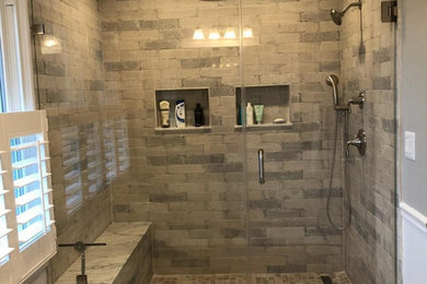 Gray and White Bathroom with Rain Shower, Wainscoting, and Pocket Doors