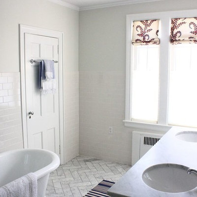 Example of a mid-sized classic master white tile and ceramic tile marble floor bathroom design in New York with furniture-like cabinets, white cabinets, a one-piece toilet, gray walls, an undermount sink and marble countertops