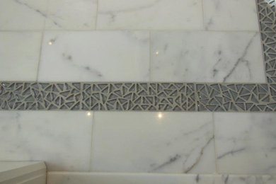 This is an example of a bathroom in New York with grey tiles.