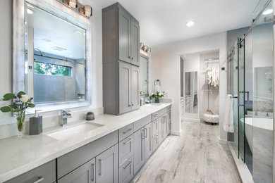 Inspiration for a mid-sized transitional master gray tile and porcelain tile porcelain tile bathroom remodel in Seattle with shaker cabinets, gray cabinets, a two-piece toilet, white walls, an undermount sink and quartzite countertops