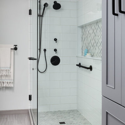Corner shower - mid-sized modern master white tile and ceramic tile porcelain tile and gray floor corner shower idea in Seattle with recessed-panel cabinets, gray cabinets, a one-piece toilet, blue walls, an undermount sink, quartz countertops, a hinged shower door and white countertops