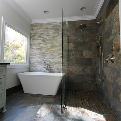 Mid-sized eclectic master multicolored tile and stone tile slate floor bathroom photo in Atlanta with an undermount sink, flat-panel cabinets, green cabinets, granite countertops, a two-piece toilet and gray walls