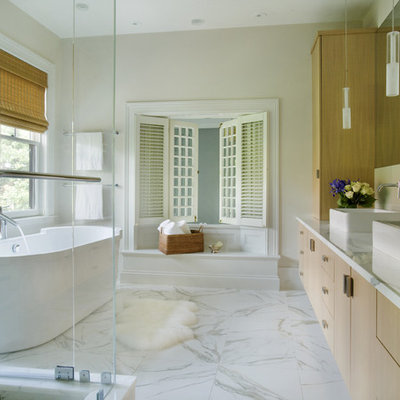 Example of a trendy marble floor and gray floor freestanding bathtub design in Boston with a vessel sink