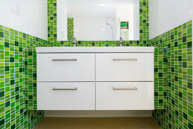 Bathroom - small contemporary master green tile and glass sheet linoleum floor bathroom idea in Vancouver with an integrated sink, flat-panel cabinets, white cabinets, tile countertops, a two-piece toilet and white walls