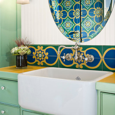 Example of a small eclectic 3/4 multicolored tile and cement tile light wood floor corner shower design in Seattle with green cabinets, tile countertops, a trough sink, a one-piece toilet, white walls, shaker cabinets and a hinged shower door
