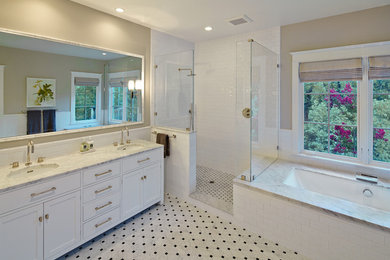 Example of a large transitional master stone tile marble floor and white floor bathroom design in San Francisco with shaker cabinets, white cabinets, a two-piece toilet, beige walls, an undermount sink, marble countertops and an undermount tub