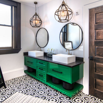 Green vanity with black and white tile floor