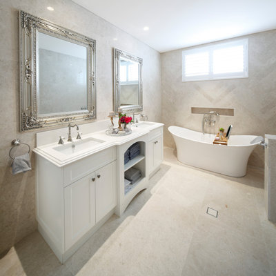 Inspiration for a timeless master beige tile and marble tile marble floor and beige floor freestanding bathtub remodel in Sydney with recessed-panel cabinets, white cabinets, quartz countertops and white countertops