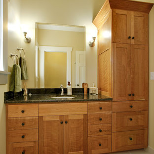 Example of an arts and crafts bathroom design in Seattle with an undermount sink, shaker cabinets and medium tone wood cabinets