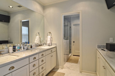 Inspiration for a large timeless master gray tile and stone tile marble floor bathroom remodel in Dallas with an undermount sink, recessed-panel cabinets, white cabinets, marble countertops, a two-piece toilet and gray walls
