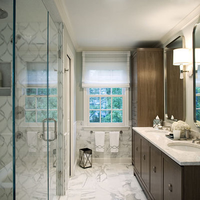 Trendy white tile and marble tile bathroom photo in New York with an undermount sink, shaker cabinets, dark wood cabinets, marble countertops, a two-piece toilet and a hinged shower door