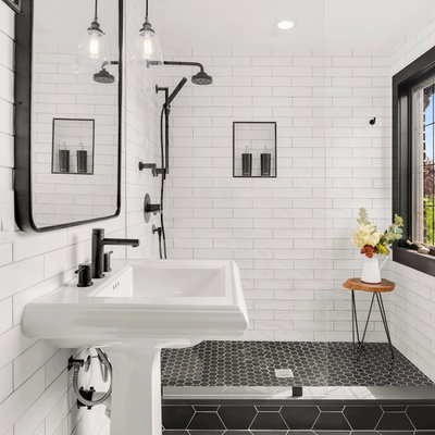 Bathroom - small transitional 3/4 white tile and subway tile ceramic tile and black floor bathroom idea in Seattle with a pedestal sink and white walls