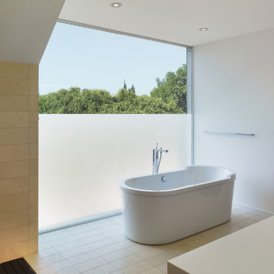 Small minimalist master beige tile and porcelain tile porcelain tile freestanding bathtub photo in Los Angeles with white walls and quartz countertops