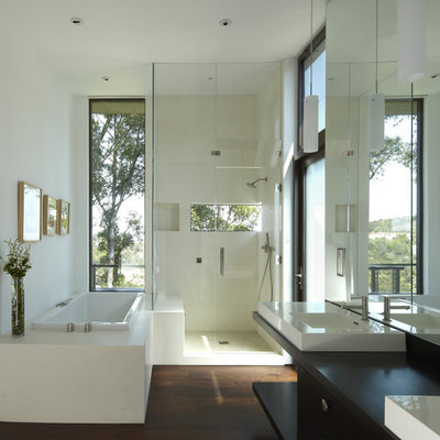 Mid-sized trendy master beige tile and stone tile dark wood floor bathroom photo in Los Angeles with a vessel sink, flat-panel cabinets, dark wood cabinets, wood countertops, white walls and black countertops