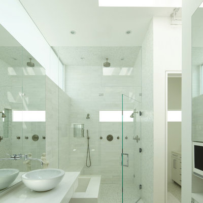Inspiration for a mid-sized modern master white tile and stone tile mosaic tile floor double shower remodel in Los Angeles with a vessel sink, flat-panel cabinets, white cabinets, marble countertops, white walls and white countertops