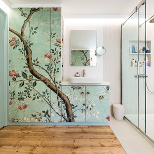 This is an example of a medium sized world-inspired bathroom in London with flat-panel cabinets, white walls, light hardwood flooring, a vessel sink, a sliding door, grey tiles and white worktops.