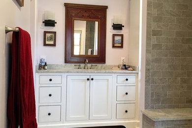 Large rural ensuite bathroom in Philadelphia with shaker cabinets, white cabinets, an alcove bath, a two-piece toilet, grey tiles, porcelain tiles, pink walls, porcelain flooring, a submerged sink, marble worktops, grey floors and a hinged door.