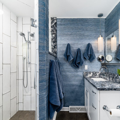 Large transitional master brown floor, medium tone wood floor and single-sink bathroom photo in Columbus with flat-panel cabinets, white cabinets, blue walls, quartzite countertops, an undermount sink, gray countertops and a built-in vanity