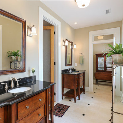 Mid-sized elegant master beige tile and porcelain tile porcelain tile bathroom photo in Charleston with an undermount sink, dark wood cabinets, furniture-like cabinets and beige walls