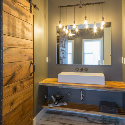 Inspiration for a mid-sized cottage master white tile and subway tile dark wood floor and brown floor bathroom remodel in Detroit with open cabinets, wood countertops, medium tone wood cabinets, brown countertops, a two-piece toilet, gray walls, a wall-mount sink and a hinged shower door