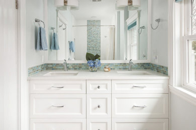 Inspiration for a mid-sized timeless 3/4 multicolored tile and mosaic tile bathroom remodel in Boston with recessed-panel cabinets, white cabinets, white walls, an undermount sink and quartzite countertops