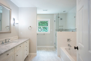 Bathroom - mid-sized transitional white tile and ceramic tile porcelain tile, gray floor and single-sink bathroom idea in Other with beaded inset cabinets, white cabinets, a two-piece toilet, gray walls, an undermount sink, marble countertops, a hinged shower door, gray countertops and a freestanding vanity