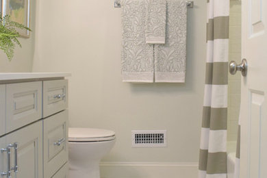 Example of a small transitional white tile and ceramic tile marble floor and multicolored floor bathroom design in Atlanta with recessed-panel cabinets, gray cabinets, a two-piece toilet, green walls, a drop-in sink, quartz countertops and white countertops