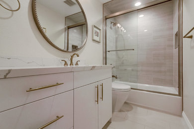 Mid-sized transitional master beige tile and porcelain tile porcelain tile and beige floor bathroom photo in San Diego with flat-panel cabinets, white cabinets, a one-piece toilet, white walls, an undermount sink, quartz countertops and white countertops
