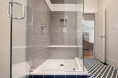 Inspiration for a mid-sized transitional kids' gray tile and porcelain tile concrete floor and multicolored floor bathroom remodel in Denver with shaker cabinets, white cabinets, a one-piece toilet, gray walls, an undermount sink, quartz countertops and a hinged shower door