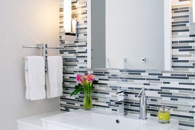Inspiration for a mid-sized contemporary multicolored tile and matchstick tile bathroom remodel in Philadelphia with flat-panel cabinets, white cabinets, gray walls, a two-piece toilet and an integrated sink
