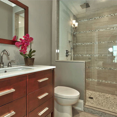 Inspiration for a mid-sized transitional 3/4 porcelain tile alcove shower remodel in Toronto with flat-panel cabinets, medium tone wood cabinets, a one-piece toilet, gray walls and an undermount sink