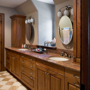 Guest Bathroom with Cherry Vanities, Limestone Floors and Red Dragon Countertops