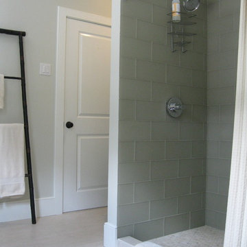 Guest bathroom with glass tile, marble penny tile and Relvinha limestone floor
