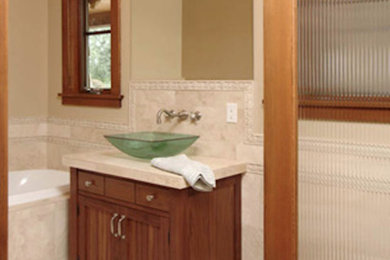 Mountain style master multicolored tile and mosaic tile bathroom photo in Seattle with an undermount sink, recessed-panel cabinets and medium tone wood cabinets