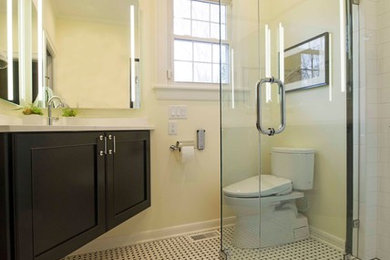 Bathroom - small transitional 3/4 white tile and ceramic tile ceramic tile and white floor bathroom idea in Charlotte with recessed-panel cabinets, black cabinets, a two-piece toilet, yellow walls, an undermount sink, quartz countertops, a hinged shower door and white countertops
