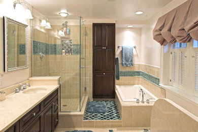 Photo of an expansive traditional ensuite bathroom in Baltimore with raised-panel cabinets, a built-in bath, a walk-in shower, a two-piece toilet, beige tiles, stone tiles, white walls, travertine flooring, a submerged sink and limestone worktops.