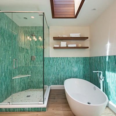 Example of an island style master blue tile, green tile and matchstick tile brown floor bathroom design in Miami with beige walls and a hinged shower door