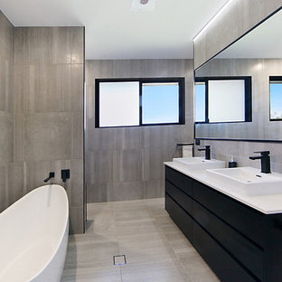 Inspiration for a mid-sized contemporary master bathroom in Townsville with flat-panel cabinets, black cabinets, a freestanding tub, brown tile, brown walls, a vessel sink, granite benchtops, brown floor, white benchtops, an alcove shower and an open shower.