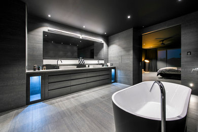 Modelo de cuarto de baño principal actual grande con armarios con paneles lisos y puertas de armario negras