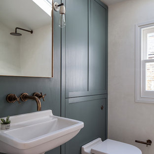 This is an example of a small contemporary bathroom in London with a wall mounted toilet, white walls and a wall-mounted sink.