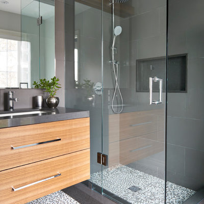 Small trendy 3/4 multicolored tile and porcelain tile mosaic tile floor corner shower photo in Toronto with flat-panel cabinets, medium tone wood cabinets, gray walls, an undermount sink, quartz countertops and a hinged shower door