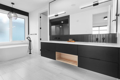Inspiration for a contemporary master black tile gray floor freestanding bathtub remodel in Edmonton with flat-panel cabinets, black cabinets, an undermount sink, quartz countertops and white countertops