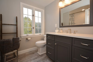 Bathroom - mid-sized craftsman white tile and subway tile porcelain tile and beige floor bathroom idea in Other with beaded inset cabinets, gray cabinets, a two-piece toilet, gray walls, an undermount sink, quartz countertops and white countertops