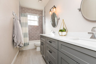 Inspiration for a tub/shower combo remodel in Albuquerque with shaker cabinets, gray cabinets, gray walls, an undermount sink and white countertops