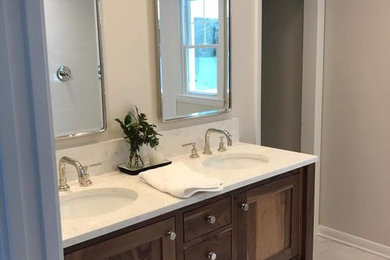 Example of a mid-sized classic master marble floor and white floor bathroom design in New York with beaded inset cabinets, medium tone wood cabinets, white walls, an undermount sink and marble countertops