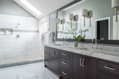 Large transitional master white tile and subway tile marble floor doorless shower photo in Indianapolis with flat-panel cabinets, brown cabinets, white walls, an undermount sink and marble countertops