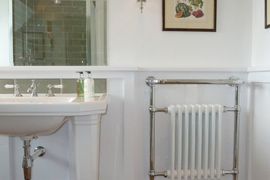 Inspiration for a medium sized country ensuite bathroom in Berkshire with a pedestal sink, a corner shower, green tiles, ceramic tiles, white walls and medium hardwood flooring.