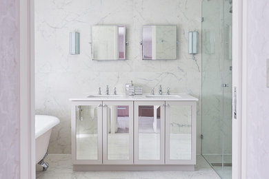 Design ideas for a contemporary ensuite bathroom in London with shaker cabinets, a claw-foot bath, an alcove shower, white tiles, stone tiles, white walls, marble flooring and a submerged sink.